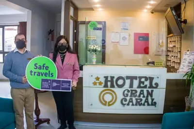 a man and a woman standing in front of a store at Gran Caral Hotel in Barranca