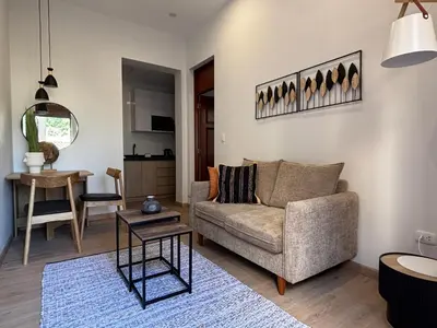 a living room with a couch and a table at Sori Apartments in Lima