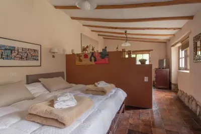 a bedroom with a bed with towels on it at Bungalows Perayoc in Urubamba
