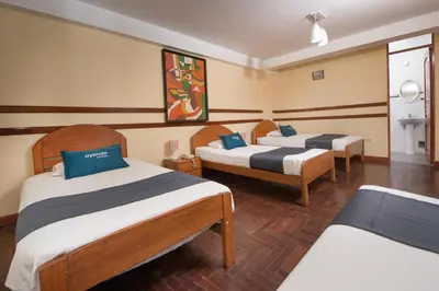 a hotel room with two beds in a room at Ayenda Posada Inn in Cusco