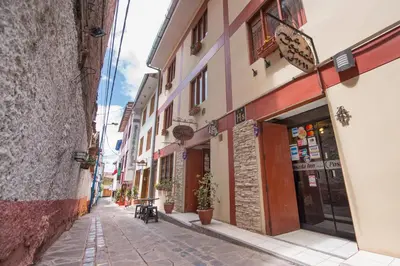 an alley in an old town with buildings at Ayenda Posada Inn in Cusco