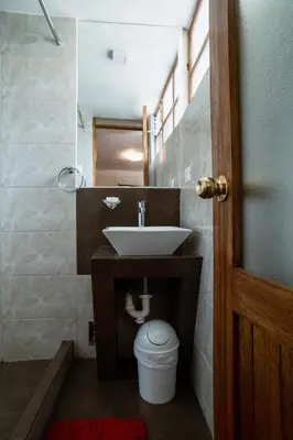 a bathroom with a sink and a toilet at Askha Cusco in Cusco