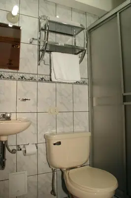 a bathroom with a toilet and a sink at Picol Hostal in Cusco
