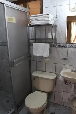 a small bathroom with a toilet and a sink at Picol Hostal in Cusco