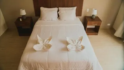 a bedroom with a bed with bows on it at Villa Oasis in Ica