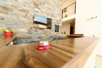 a table with a bell sitting on top of it at Villa Oasis in Ica