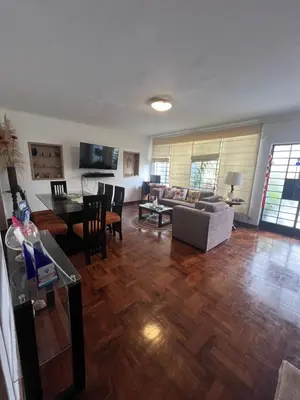 a living room with a couch and a table at Uli´s house in Lima