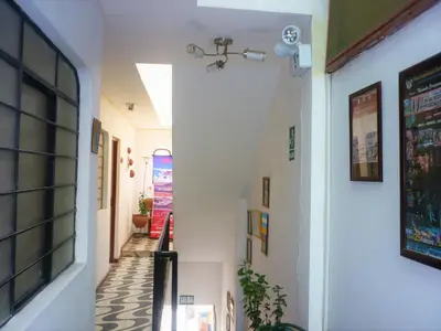 a hallway in a house with a stairway at Anccalla Inn Guesthouse in Nazca