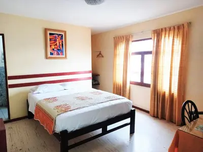 a bedroom with a bed and a window at Anccalla Inn Guesthouse in Nazca