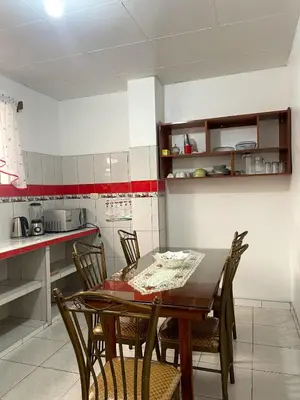 a kitchen with a dining room table and chairs at Hospedaje Familiar Laos in Oxapampa