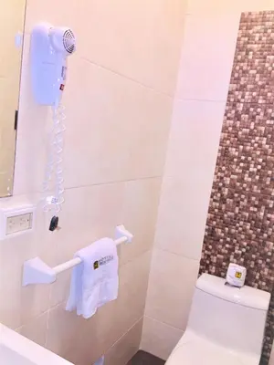 a bathroom with a toilet and a phone at Hostal Carlos Tenaud in Lima