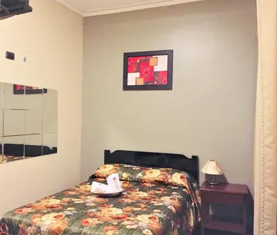 a bedroom with a bed with a stuffed animal on it at Hostal Carlos Tenaud in Lima