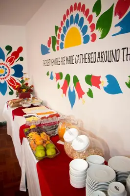 a table with a red and white table cloth with food at Cusco Plaza Nazarenas in Cusco