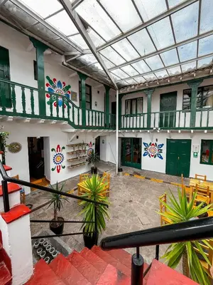 arium of a building with green doors and plants at Cusco Plaza Nazarenas in Cusco