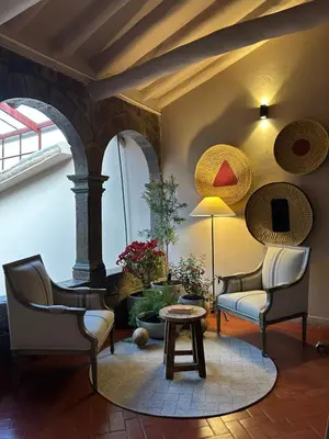 a living room with two chairs and a table at Hotel Cusco Plaza Saphi in Cusco