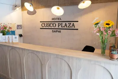 a hotel lobby with a counter with flowers on it at Hotel Cusco Plaza Saphi in Cusco