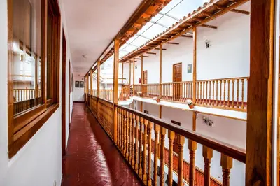 an empty hallway in an old building with wooden railings at Hotel Cusco Plaza Saphi in Cusco