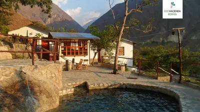 a small pool of water in front of a building at Eco Hacienda Roman in Machu Picchu