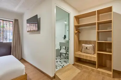 a bedroom with a bed and a mirror at Centro by Casa Andina Cusco Saphi in Cusco