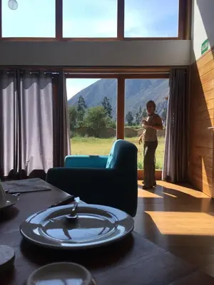 a woman standing in a room with a window at Casafranca in Ollantaytambo