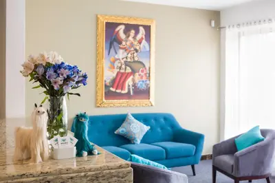 a living room with a blue couch and a table at Muru Homely Hotel Cusco in Cusco