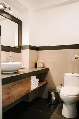 a bathroom with a sink and a toilet at Muru Homely Hotel Cusco in Cusco