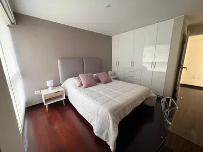 a bedroom with a bed with two pink pillows at El Golf los inkas luxury Penthouse in Lima
