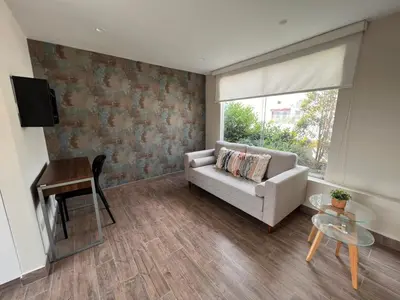 a living room with a couch and a table at El Golf los inkas luxury Penthouse in Lima