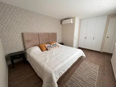 a bedroom with a large white bed in a room at El Golf los inkas luxury Penthouse in Lima