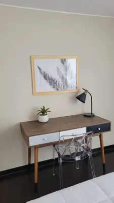 a desk with a lamp and a plant on it at El Golf los inkas luxury Penthouse in Lima