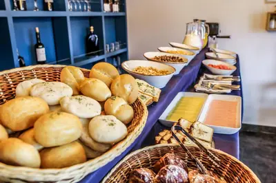a buffet with baskets of bread and other foods at Tariq Boutique in Cusco