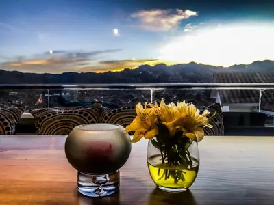 a vase with yellow flowers sitting on a table at Tariq Boutique in Cusco