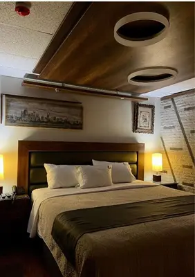 a bedroom with a large bed and two lights at Hotel El Marqués in Lima