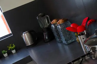 a counter top with two glass jars on it at Jazmines Lodging in Ica