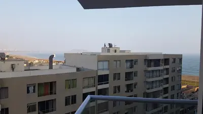a view of a building with the ocean in the background at Lima Flats in Lima