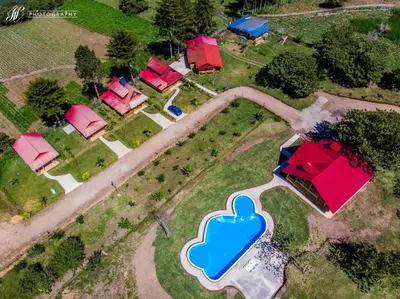an overhead view of a house with a blue cloud at HASSINGER RANCH Cabañas in Oxapampa