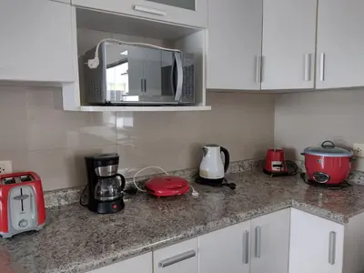 a kitchen with a counter top with appliances on it at Beachfront Condo San Miguel in Lima