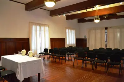 a large room with chairs and a table with a white tablecloth at DM Hoteles Mossone - Ica in Ica