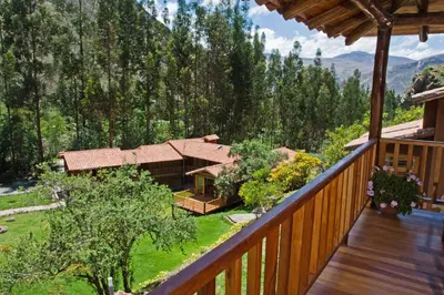 a balcony of a house with a view of the mountains at Sacred Dreams Lodge in Urubamba