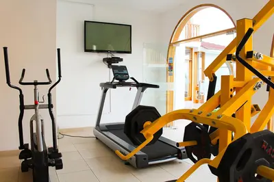 a room with a gym with a treadmill and a tv at Hotel Boutique La Angostura in Ica