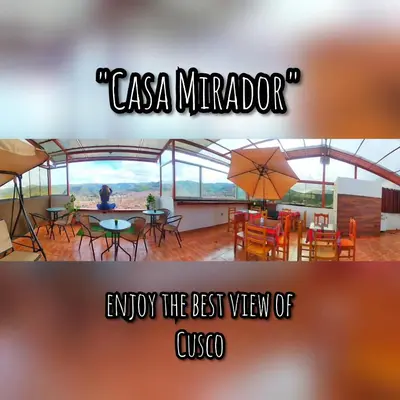 a picture of a restaurant with a table and an umbrella at Casa Mirador guesthouse in Cusco
