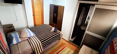 a small room with a bed and a mirror at Casa Mirador guesthouse in Cusco