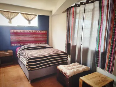 a small bedroom with a bed and a window at Casa Mirador guesthouse in Cusco