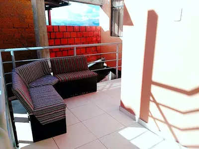 a chair sitting on a balcony with red seats at Casa Mirador guesthouse in Cusco