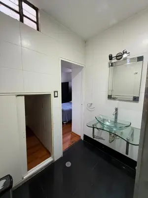 a bathroom with a glass sink and a mirror at Private room in Miraflores; Exclusive entrance! in Lima