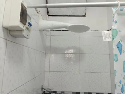 a bathroom with a toilet and a tv on the wall at Room 5 Star Miraflores in Lima