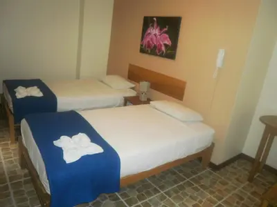 a hotel room with two beds with towels on them at Hospedaje La Videna in Lima