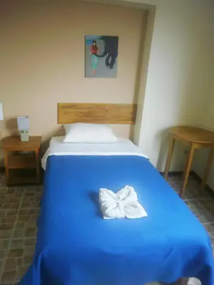 a blue bed with a white bow on it at Hospedaje La Videna in Lima