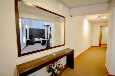 a mirror on the wall of a living room at Ankawa Hotel Boutique in Cusco