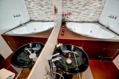 a bathroom with two sinks and two bath tubs at Ankawa Hotel Boutique in Cusco
